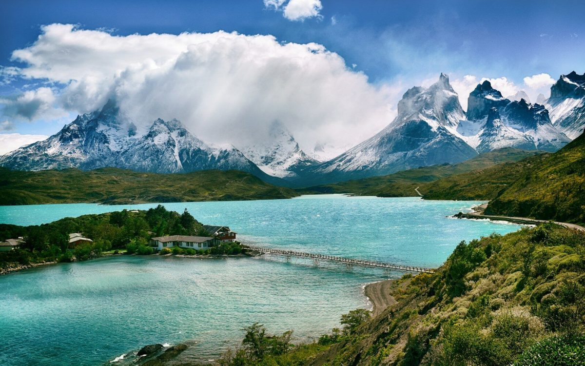 a lake near a snow-covered mountain during the day
